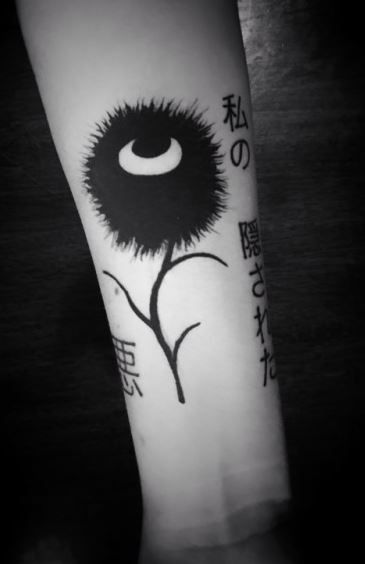 a black and white photo of a tattoo on the arm