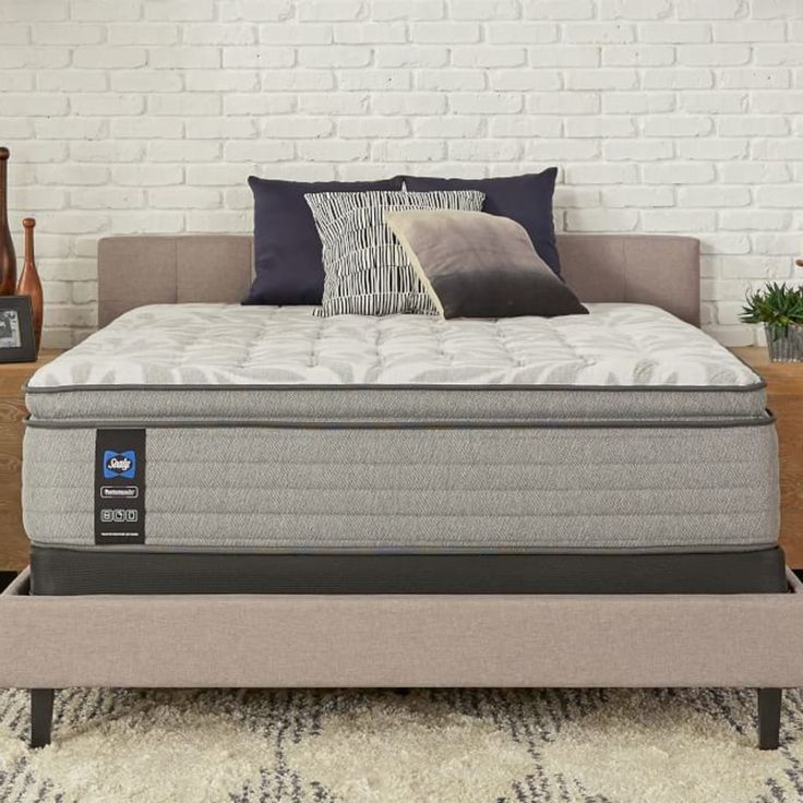 an image of a mattress in the middle of a bed frame with pillows on it