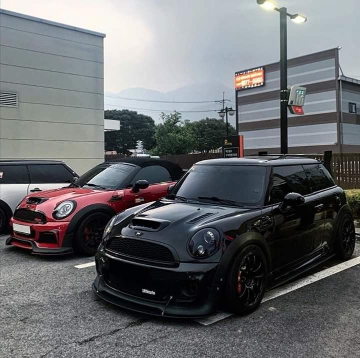 three cars parked in a parking lot next to each other