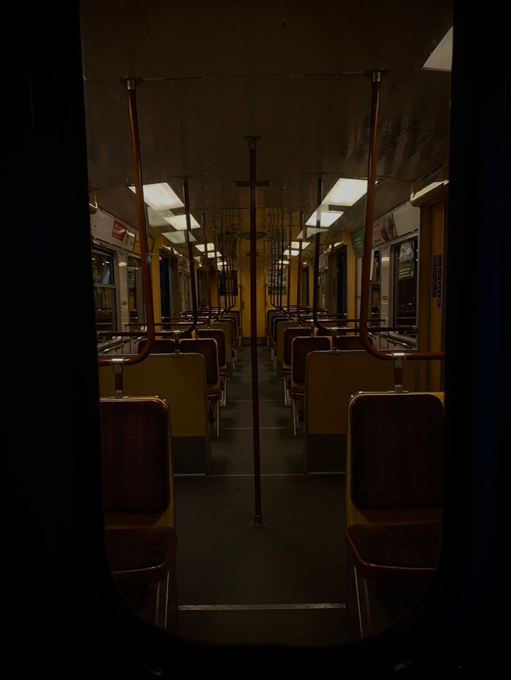 the inside of a train car with no people on it at night or day time