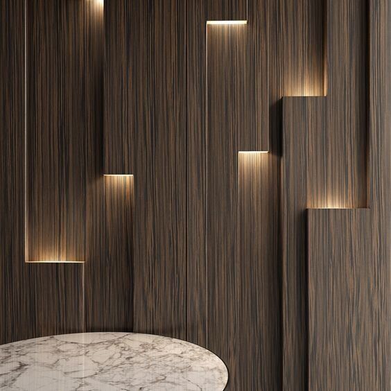 a marble table in front of wooden walls with recessed lights on it and a round white dining room table