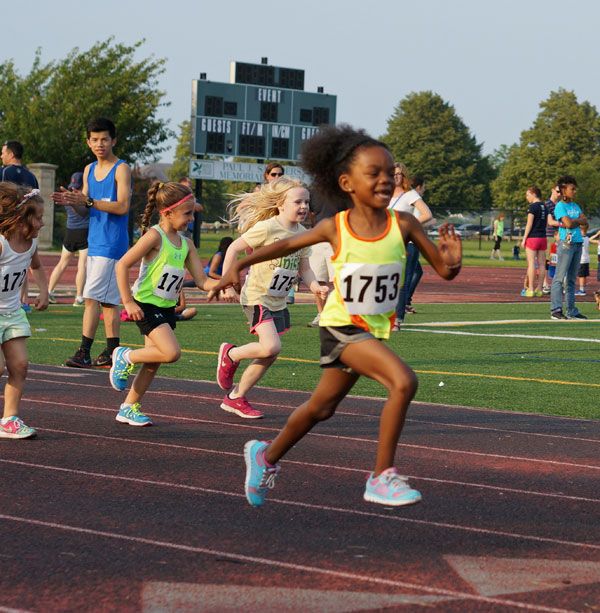 young children running on a track in a race