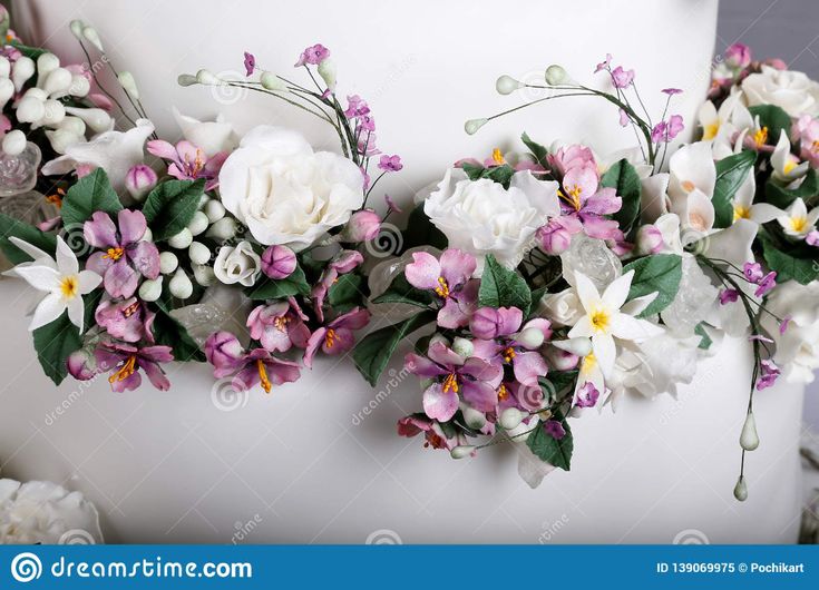 wedding cake decorated with flowers and greenery stock photo - image 397984