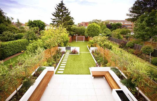 an outdoor garden with grass and wooden benches