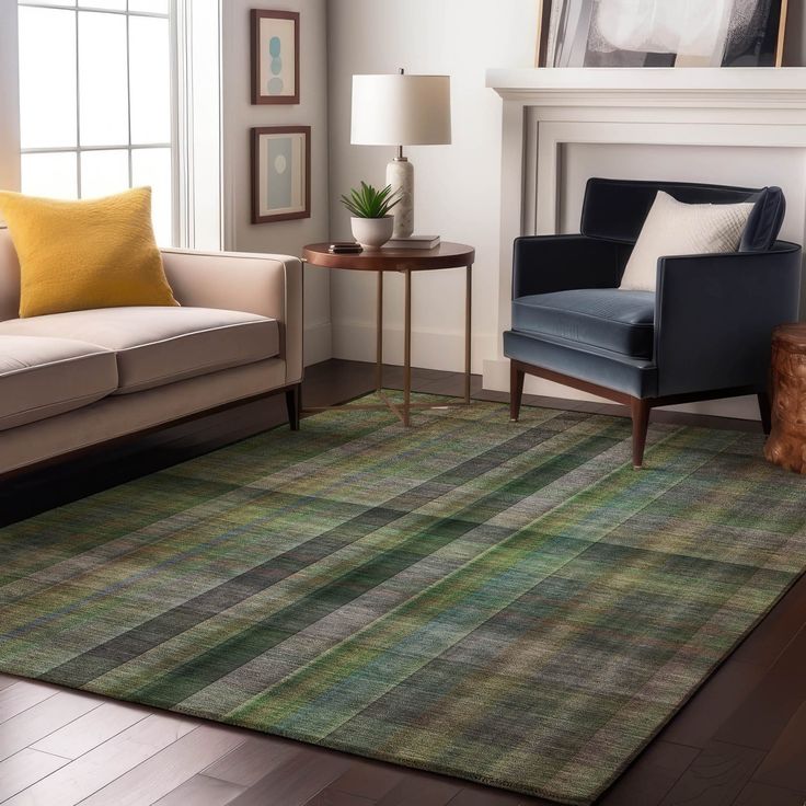 a living room filled with furniture and a rug on top of a hard wood floor