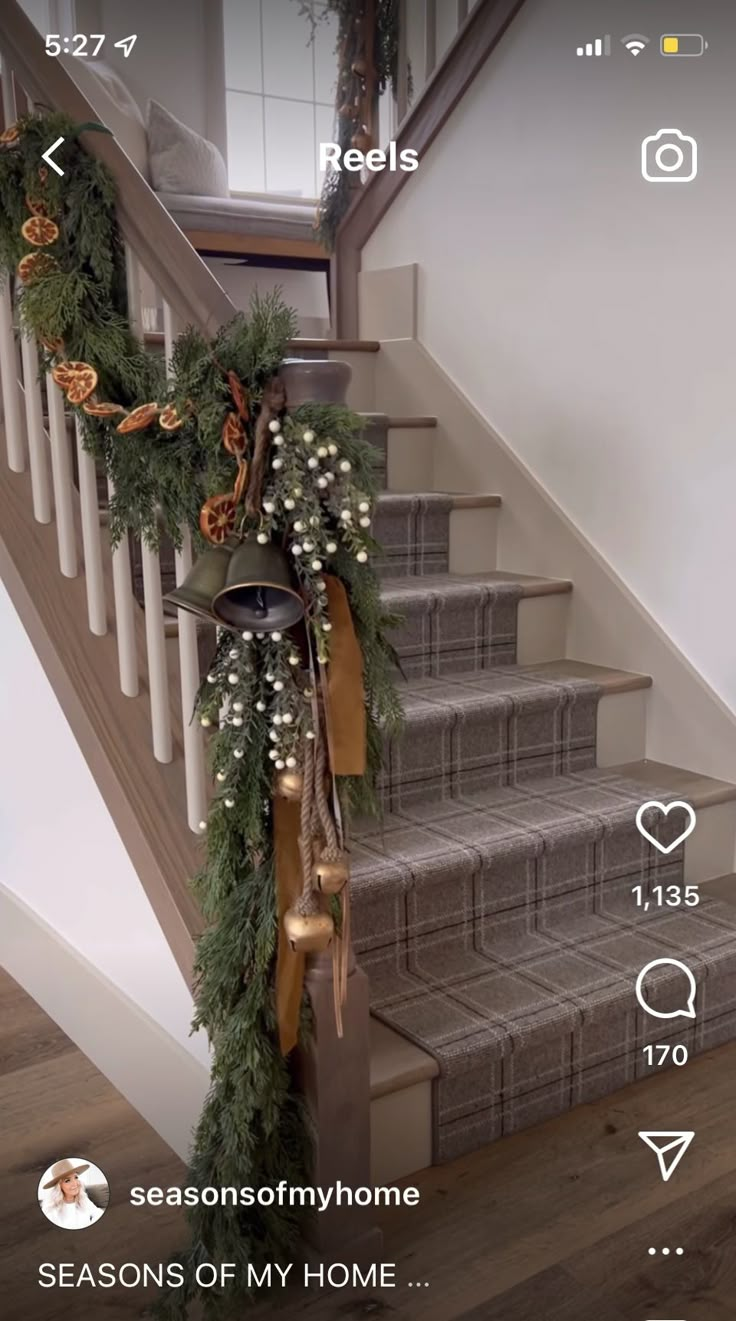 the stairs are decorated with greenery and bells for garlands on each handrail