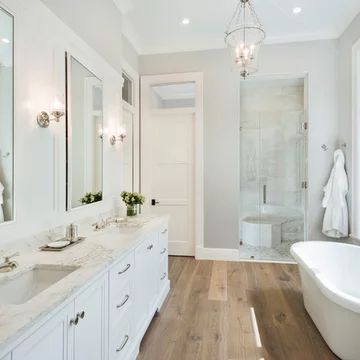 a large bathroom with two sinks and a bathtub