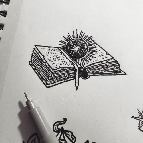 a drawing of a book with a compass on it