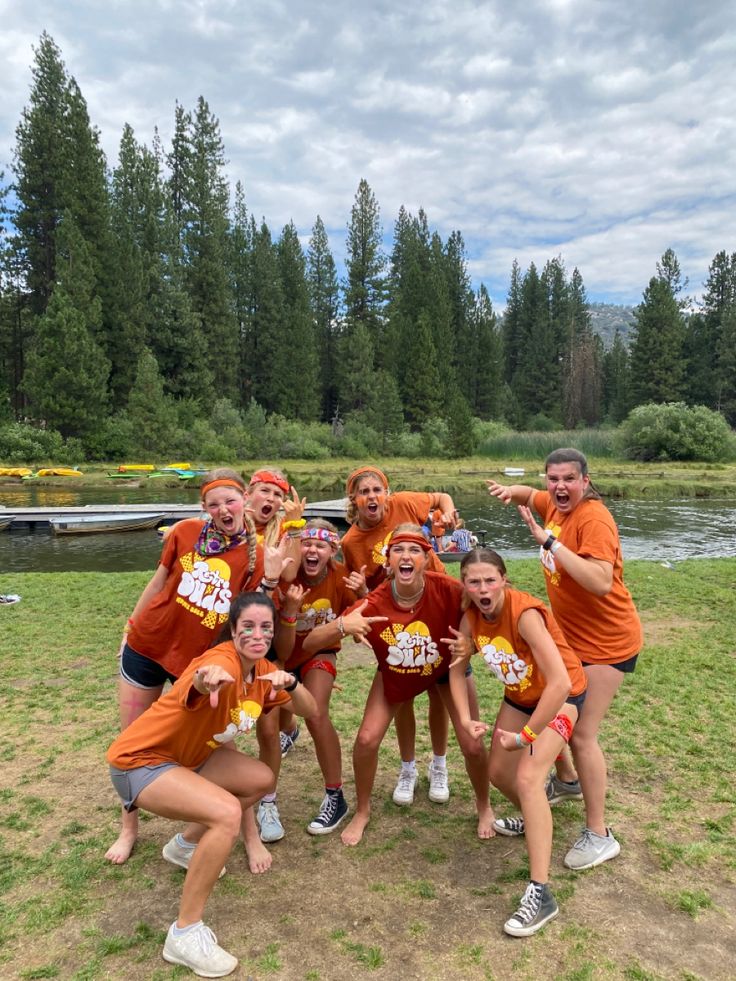 a group of women in orange shirts posing for a photo