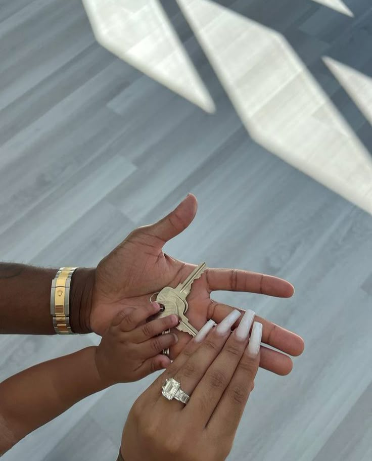 two people holding keys in their hands