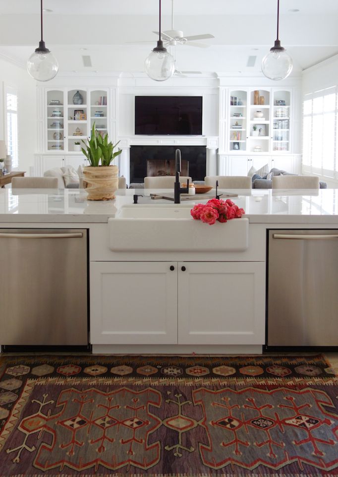 a kitchen with white cabinets and stainless steel dishwasher, stove top oven and sink