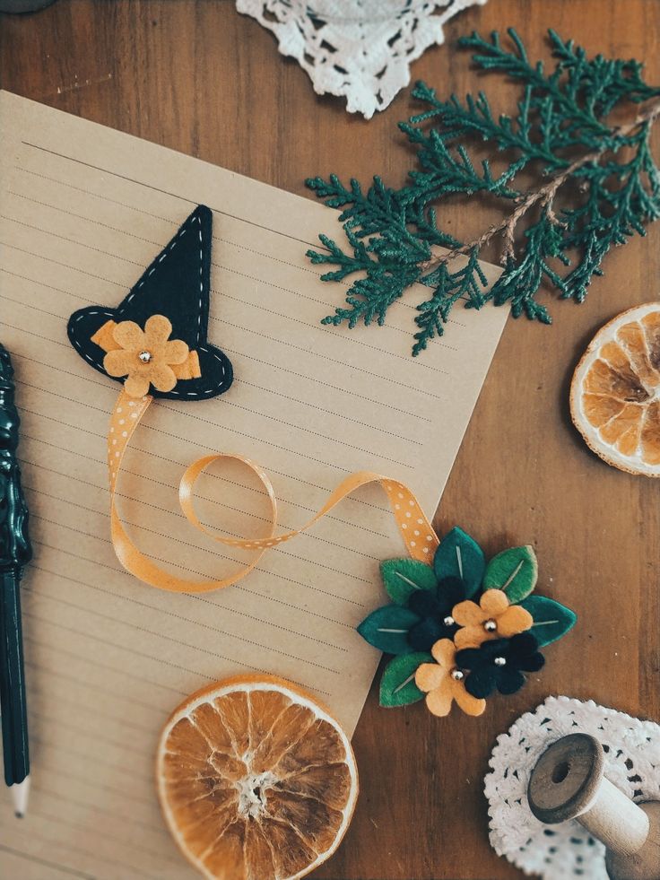 orange slices and other decorations on top of a notepad