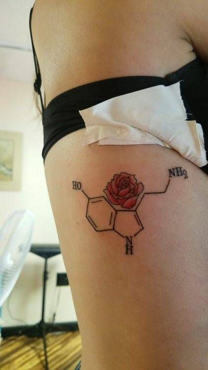 a woman with a rose tattoo on her thigh