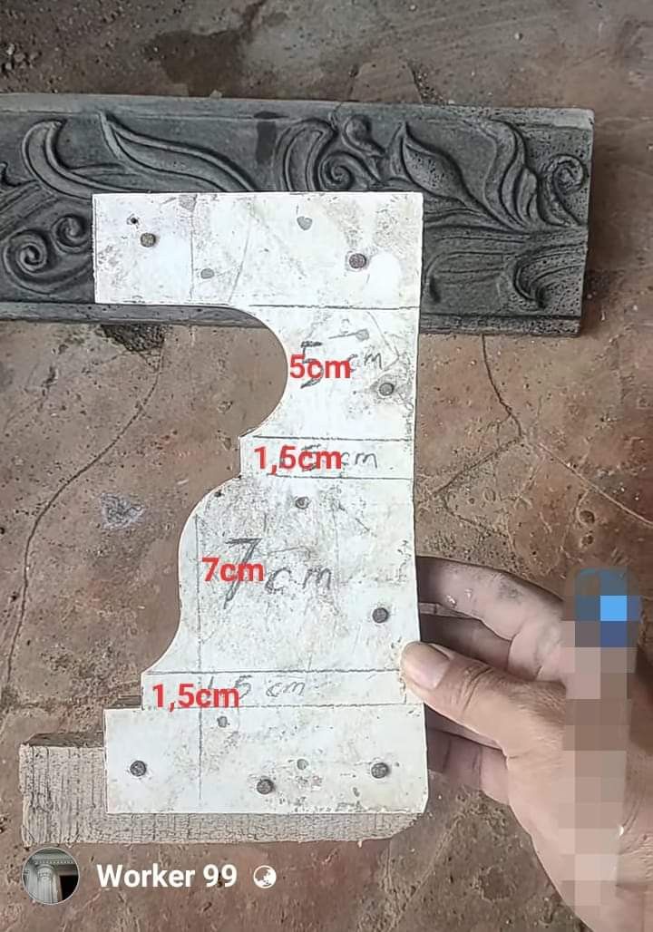 a person is holding a piece of wood with the number one on it and measurements