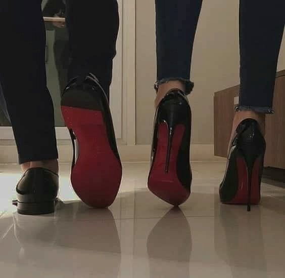 two people wearing high heels standing next to each other