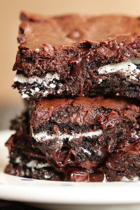 three brownies stacked on top of each other with oreo cookies and cream in the middle