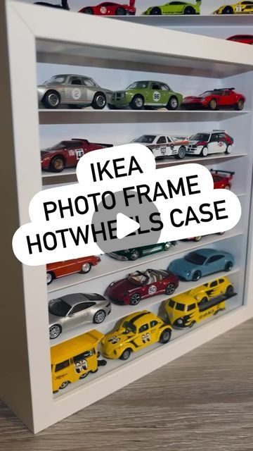 there is a display case with many cars on the shelves and below it are words that read ikea photo frame, hot wheels case