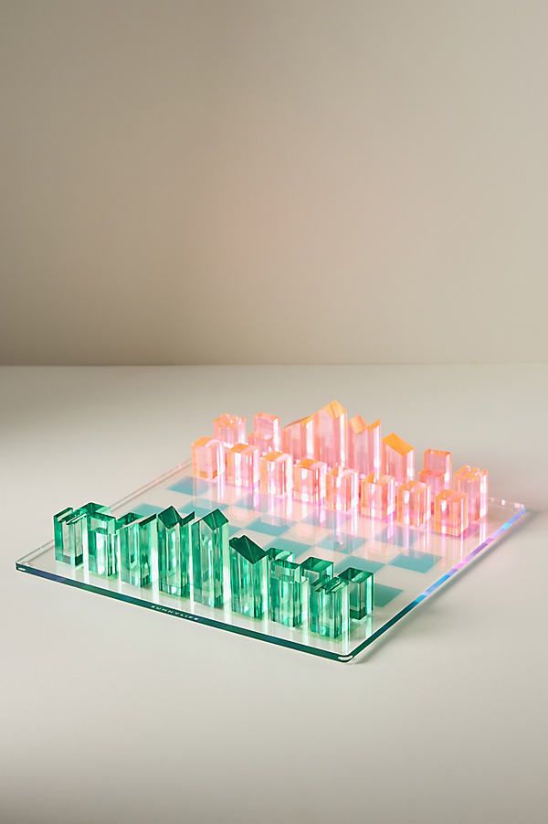 a glass tray that has many different colored objects on top of it and is sitting on a table