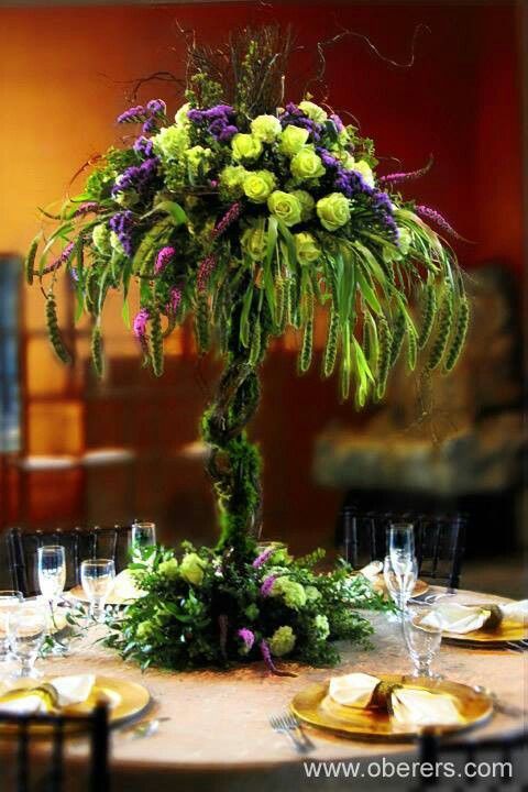 the centerpiece is made from flowers and greenery, along with other place settings