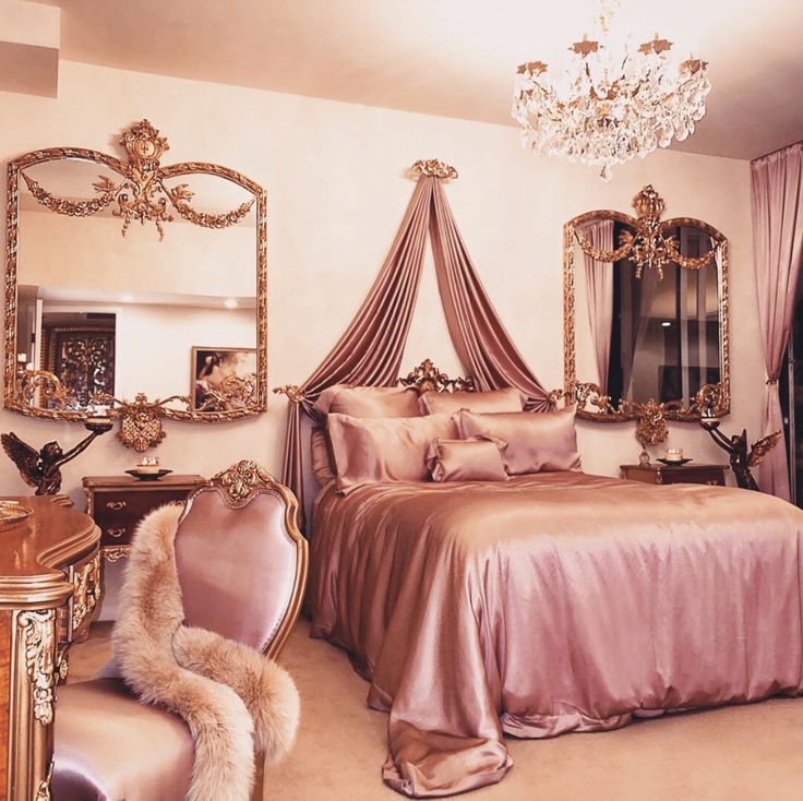 a bedroom with a bed, chair and chandelier on the ceiling is decorated in gold