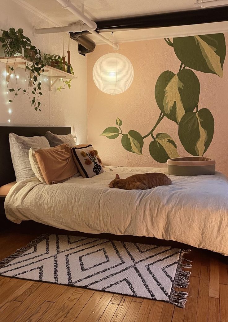 a cat laying on top of a bed in a bedroom