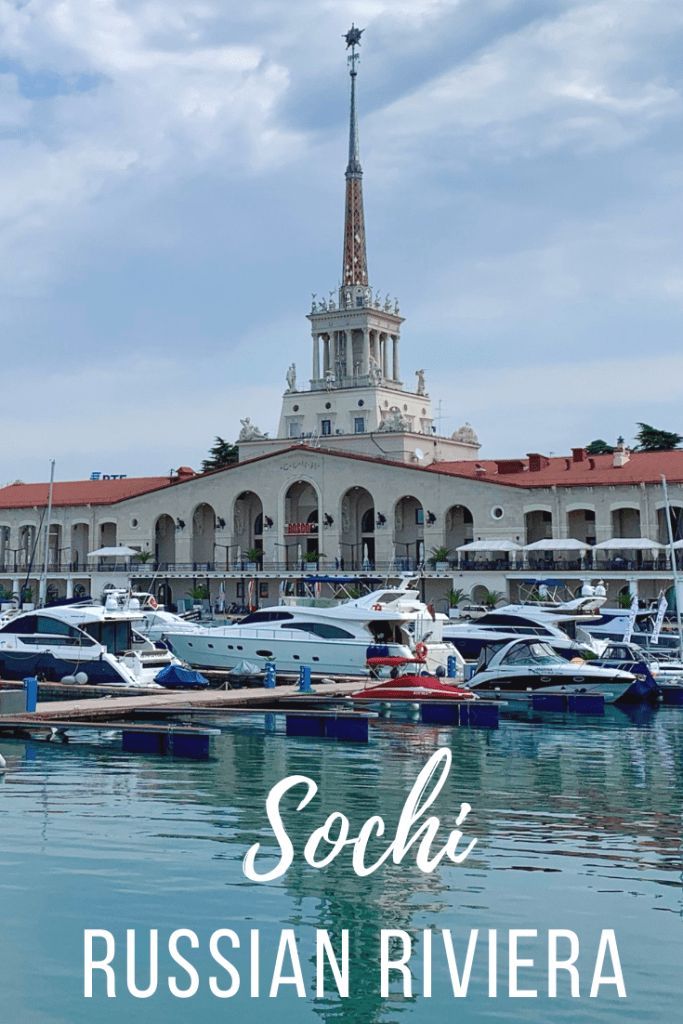 boats are docked in front of a large building with a steeple on the top