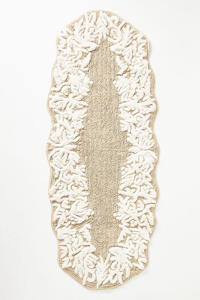 a piece of art that is made out of jute and white yarn on a wall