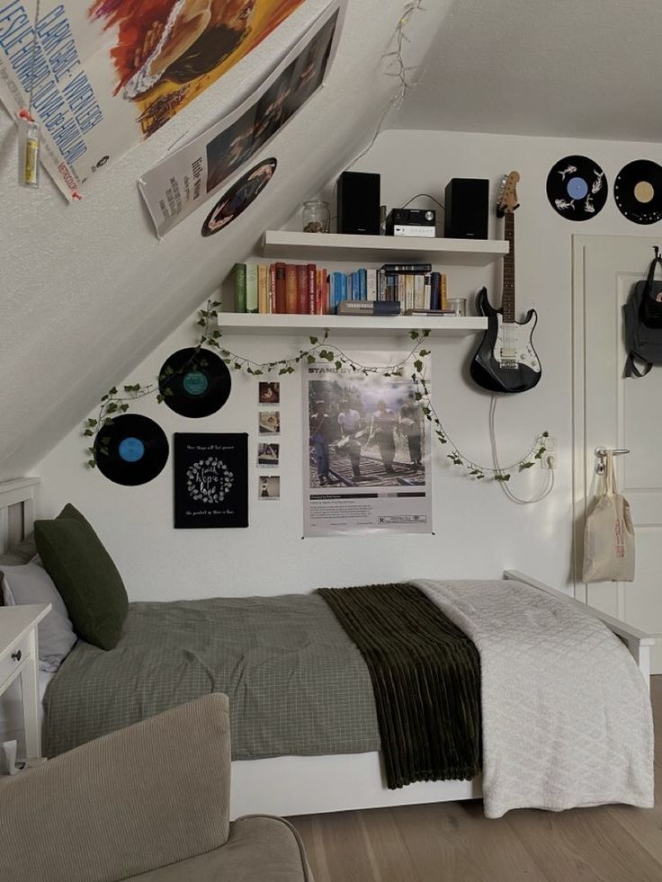 a bed sitting under a slanted ceiling next to a book shelf filled with books