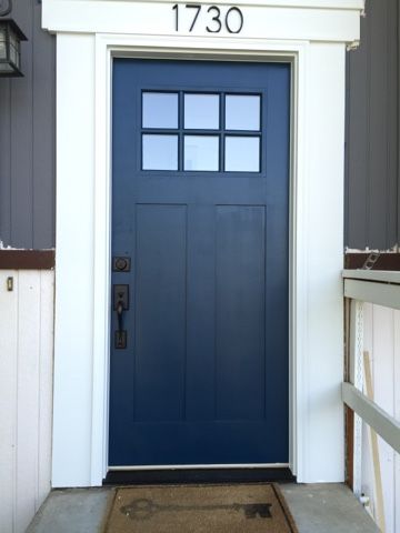 a blue front door on a house with the number 1230 painted on it's side