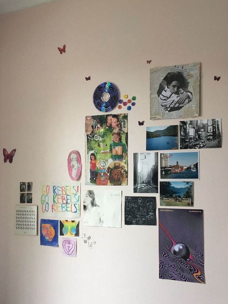 the wall is covered with many different pictures and magnets on it's side