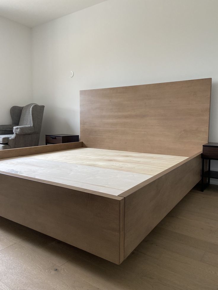 a large bed sitting on top of a hard wood floor