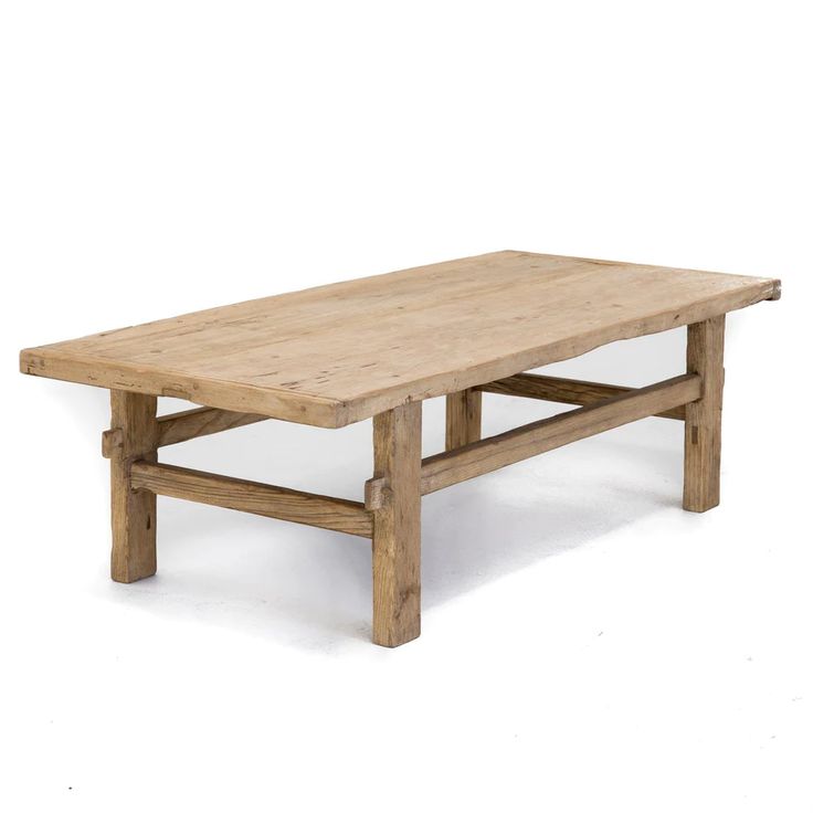 a wooden table sitting on top of a white floor