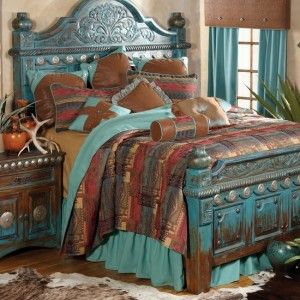 a bedroom with a bed, dresser and window in the background is decorated with blue curtains