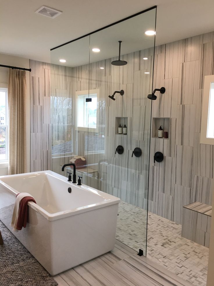 a bathroom with a large tub and walk in shower