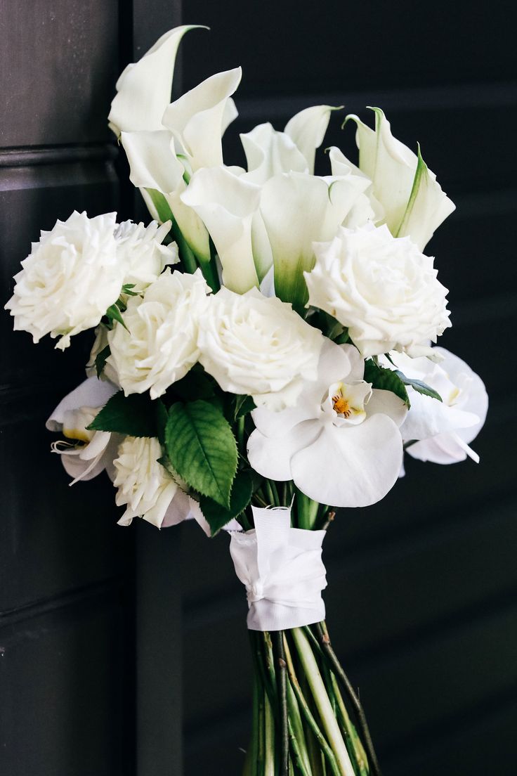 a bouquet of white flowers sitting on top of a table