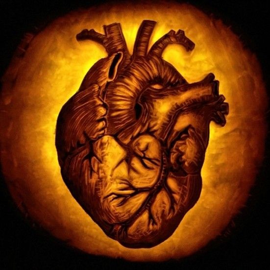 a pumpkin carved to look like a human heart