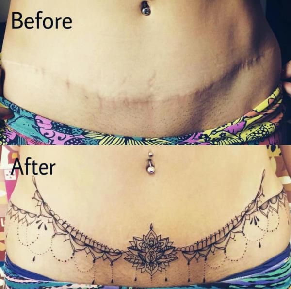 a woman's stomach with tattoos on the side and an upside down view of her belly