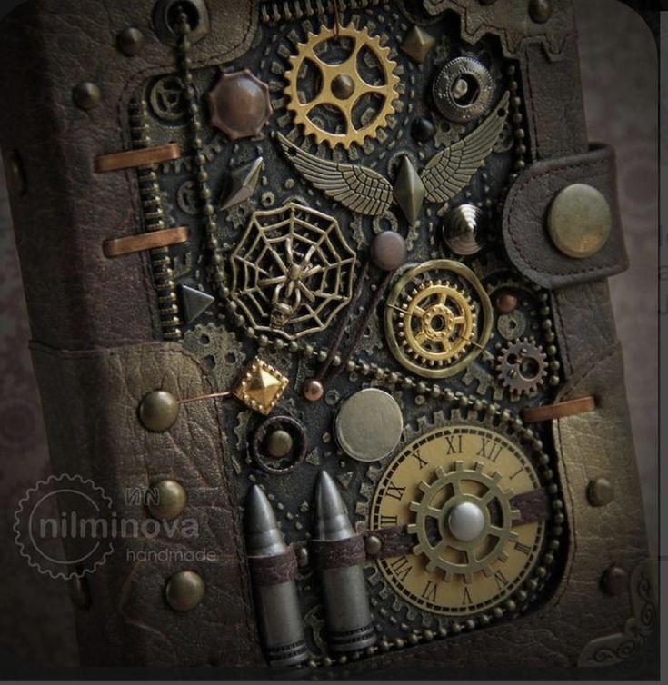 the inside of an altered book with gears and other things on it's cover