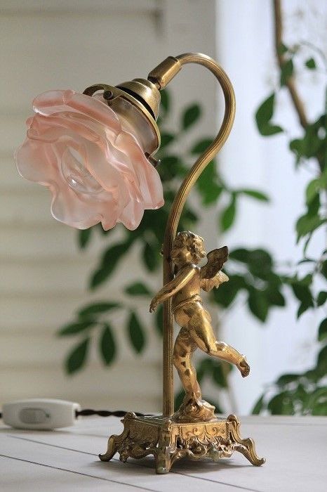 a lamp with a pink flower on top of it