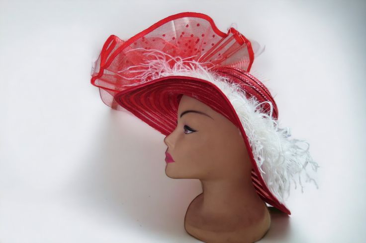 "This festively fun hat is a true attention getter.   This is made on red straw hat.  What a great Church Hat!  It features fabulous white ostrich feathers.    This was made with Church, Mothers Day and the Kentucky derby in mind -   Our sweater crew love to display their talents on things other than sweaters, this is just one example.   This is an extravagant fun hat.   You can show this off at any event, or just out for coffee. measurements: front to back  16\" bottom to top of  12\" 5 1/2\" b Brimmed Mini Hats With Feather Trim For Party, Summer Party Hat With Feather Trim, Red Hats For Holiday Party, Summer Hats With Ostrich Feathers For Races, Red Hats For Spring Gifts, Brimmed Party Mini Hats With Feather Trim, Summer Mini Hats With Ostrich Feathers For Races, Brimmed Party Hats With Feather Trim, Summer Ostrich Feather Mini Hats For Races