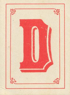 an old red and white postcard with the letter o in it's center