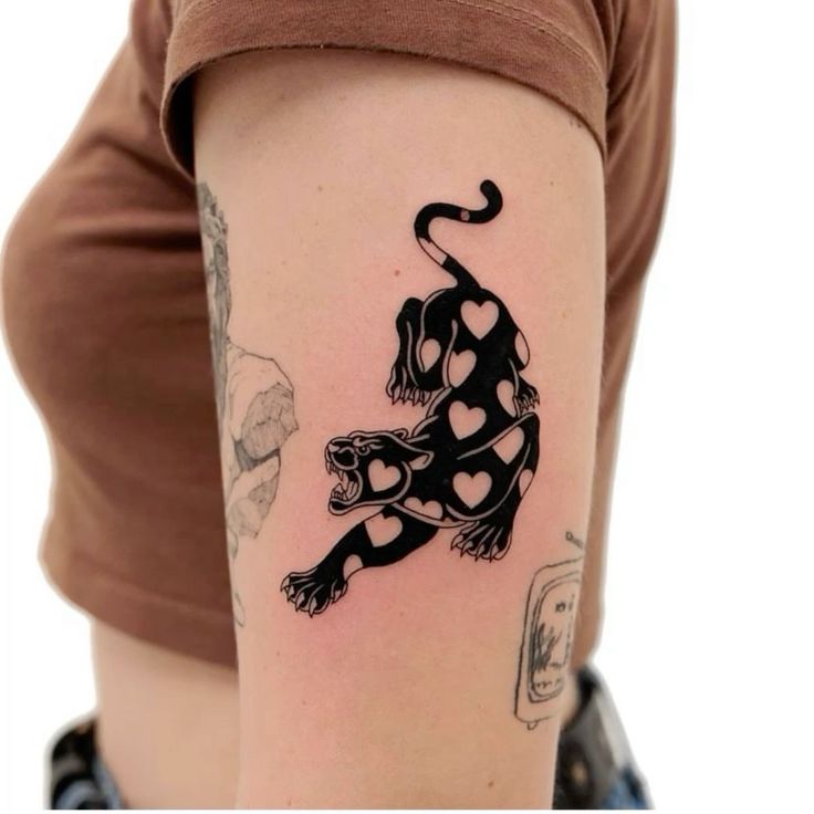 a woman's arm with a tattoo on it that has a dog and hearts