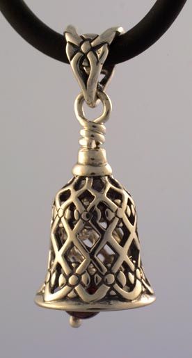 a silver bell is hanging from a black leather cord with an intricate design on it