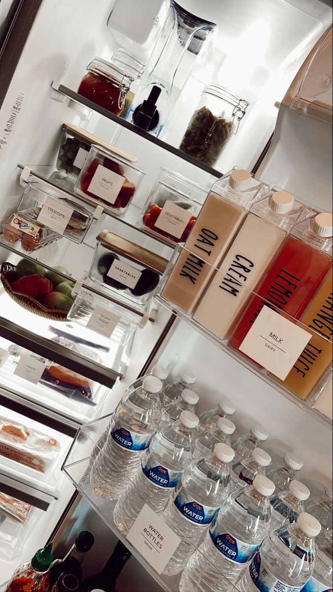 an open refrigerator filled with lots of different types of drinks and condiments on shelves