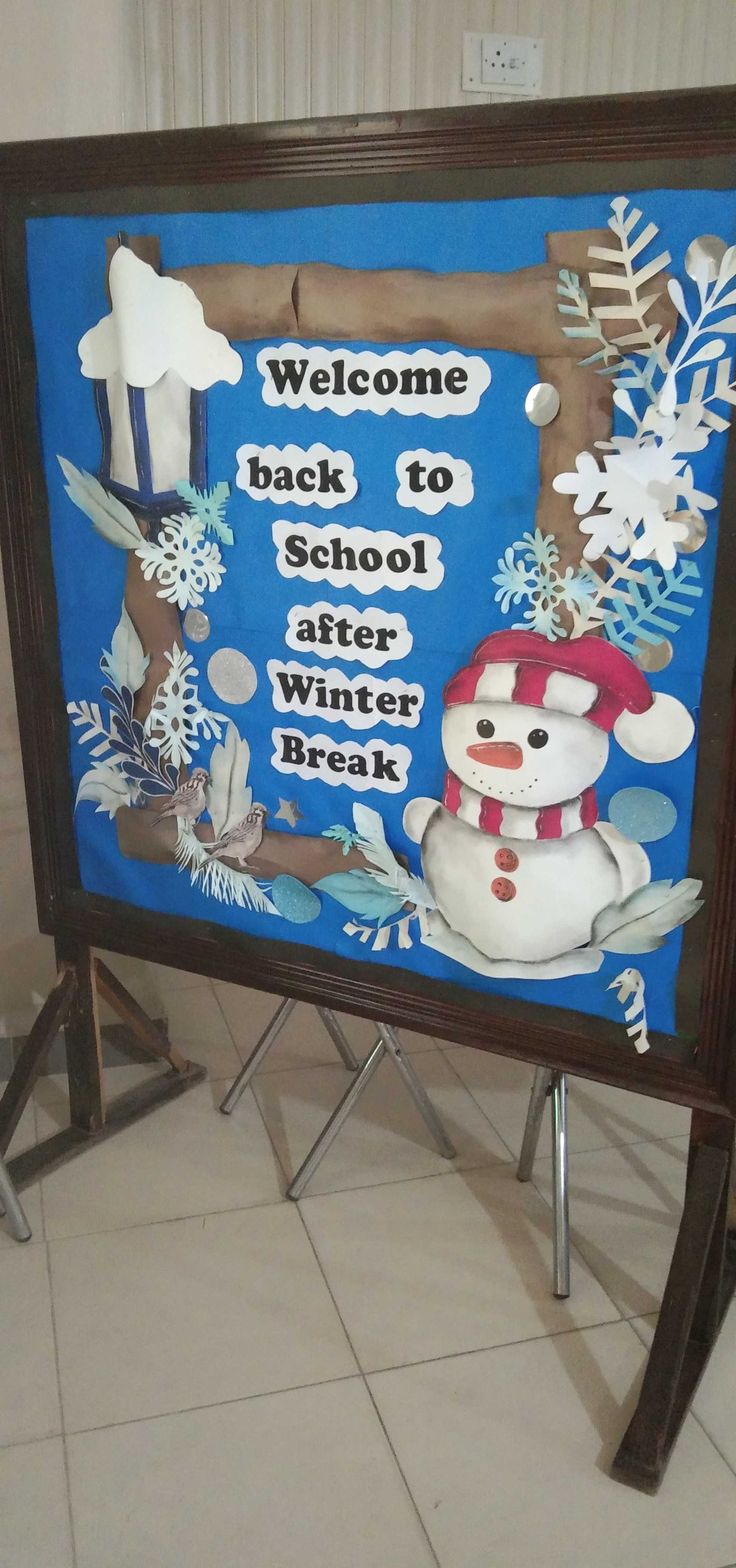 a welcome back to school sign with a snowman and bird on it, in front of a tiled floor