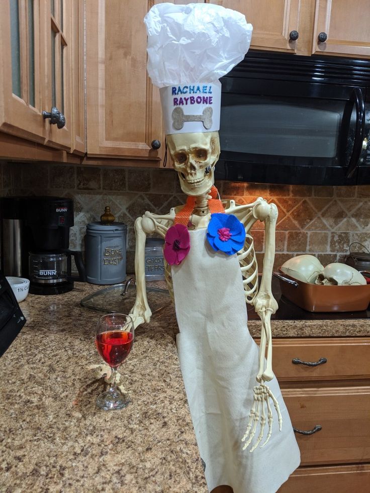 a skeleton wearing a chef's hat and holding a doughnut in the kitchen