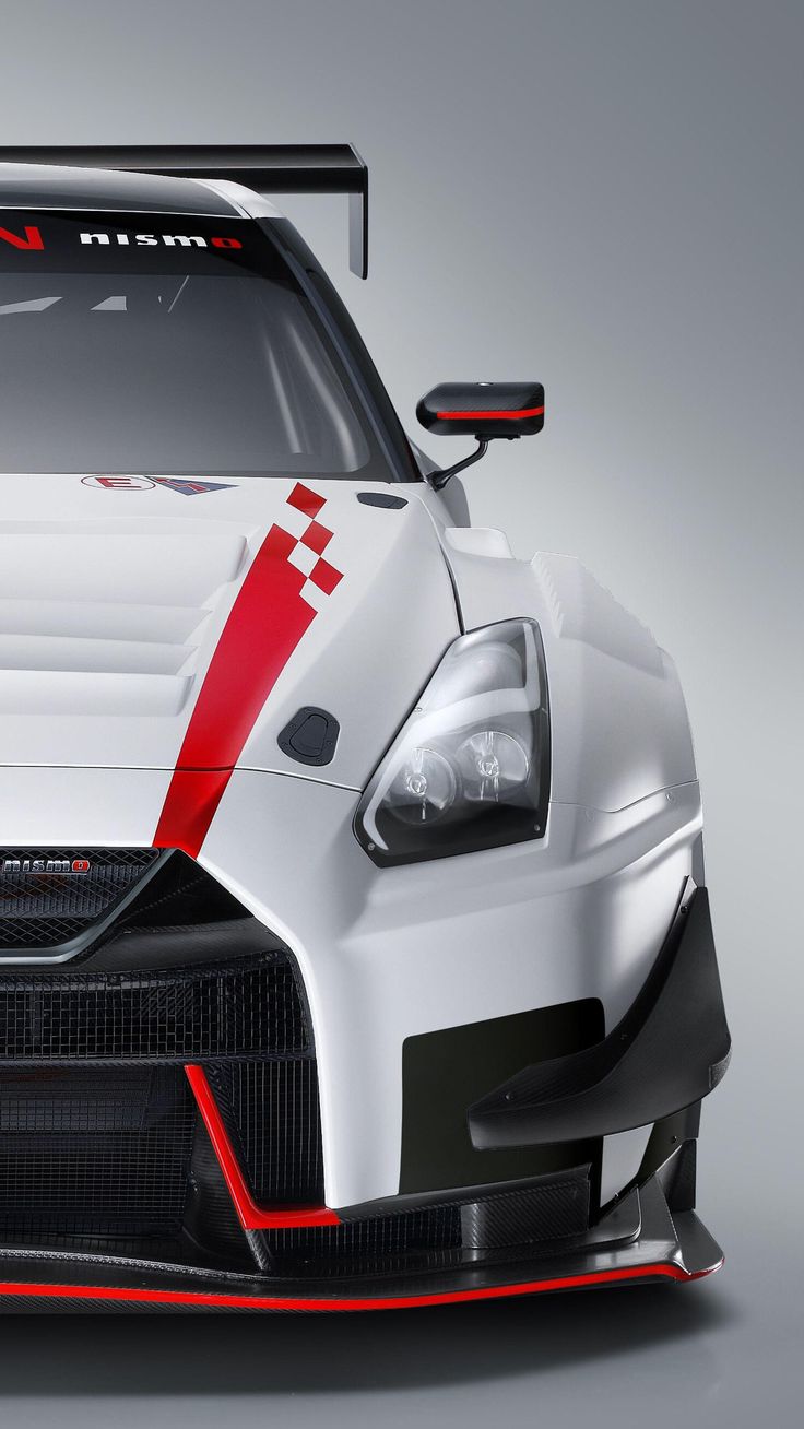 the front end of a white sports car with red stripes on it's hood