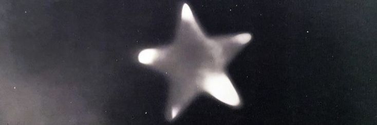 a blurry image of a white star on a black background