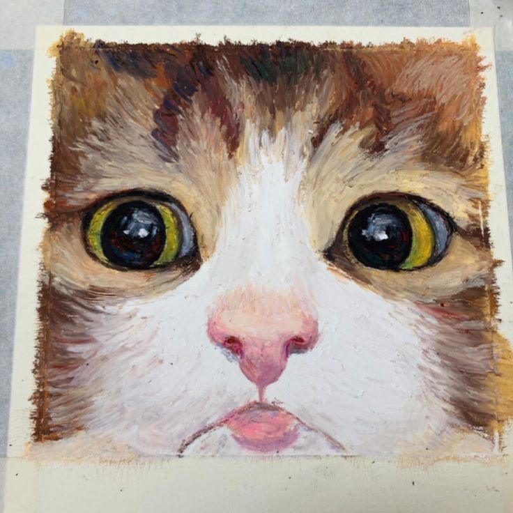 a painting of a cat's face with yellow eyes