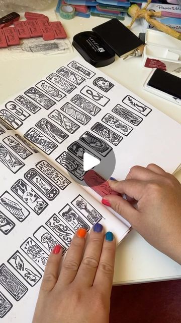 a woman is working on some type of sticker art project with her fingers and thumbnails